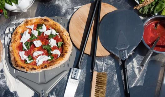 Wooden Acacia pizza peel on a kitchen counter, perfect for sliding pizzas in and out of the oven.