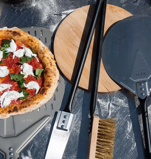 Wooden Acacia pizza peel on a kitchen counter, perfect for sliding pizzas in and out of the oven.