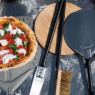 Wooden Acacia pizza peel on a kitchen counter, perfect for sliding pizzas in and out of the oven.