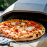 A selection of top-rated indoor and outdoor pizza ovens for 2025, including wood-fired, gas, and electric models.