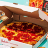 Gourmet monthly pizza subscription box featuring an assortment of artisanal pizzas in a stylish branded cardboard box.