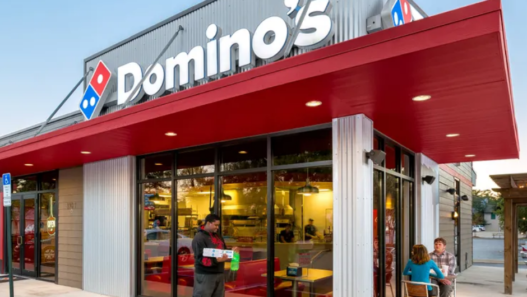 Exterior of a Domino’s restaurant with branded signage, illustrating the chain’s move to adopt blockchain‑based AI for streamlined operations.