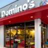Exterior of a Domino’s restaurant with branded signage, illustrating the chain’s move to adopt blockchain‑based AI for streamlined operations.