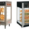 Commercial pizza kitchen workspace showcasing dough mixer, pizza oven, prep tables, and ingredient shelving—essential pizzeria supplies.
