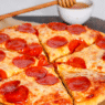 Hot Honey Pepperoni Pizza with curled cup-and-char pepperoni and a spicy honey drizzle on golden crust