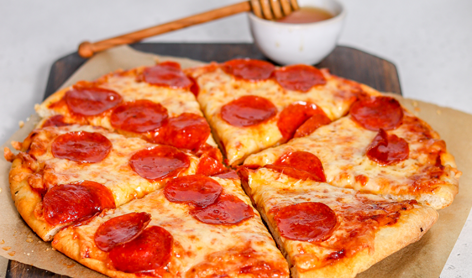 Hot Honey Pepperoni Pizza with curled cup-and-char pepperoni and a spicy honey drizzle on golden crust