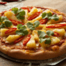 Overhead view of pineapple red chili cilantro pizza with golden crust, fresh herbs, and spicy chilies on a wooden board