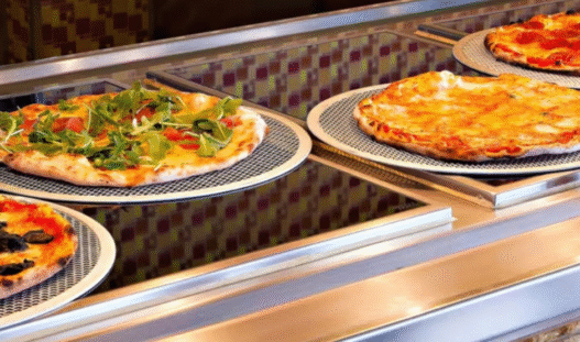 Carnival cruise pizza station with freshly baked slices on a late-night deck