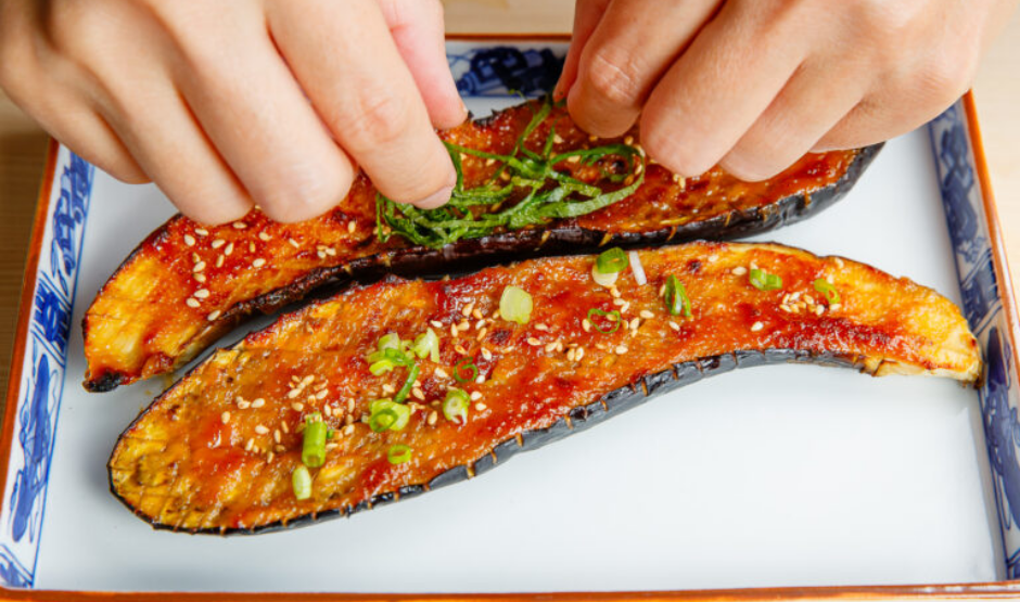 Miso Eggplant Pizza topped with miso-glazed eggplant slices, melted cheese, scallions, and sesame seeds on a golden crispy crust