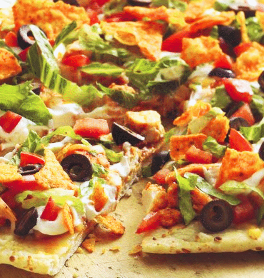 A freshly baked Chicken & Purple Potato Street Taco Pizza with melted cheese, purple potato slices, red onion, and cilantro on a wooden board