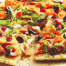 A freshly baked Chicken & Purple Potato Street Taco Pizza with melted cheese, purple potato slices, red onion, and cilantro on a wooden board
