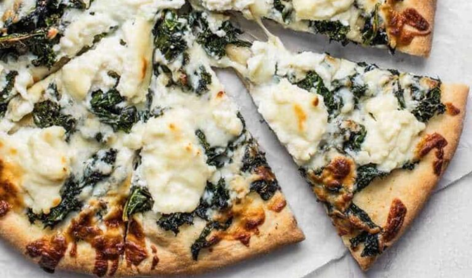 Crispy Kale & Lemon Ricotta Pizza topped with golden crust, creamy ricotta, lemon zest, and crunchy kale leaves
